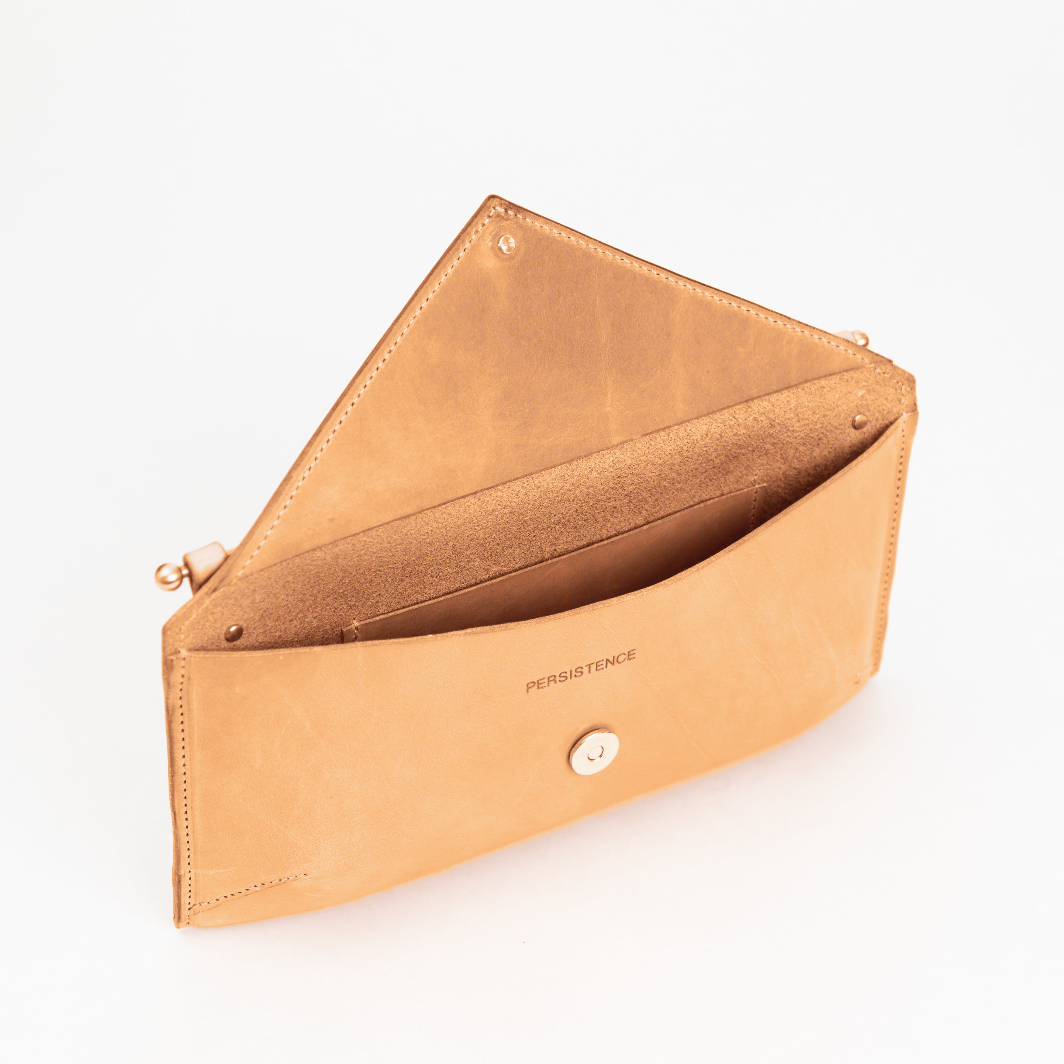 East West Envelope | Toast in full-grain leather with soft interior, magnetic closure, and removable crossbody strap detailing luxury craftsmanship