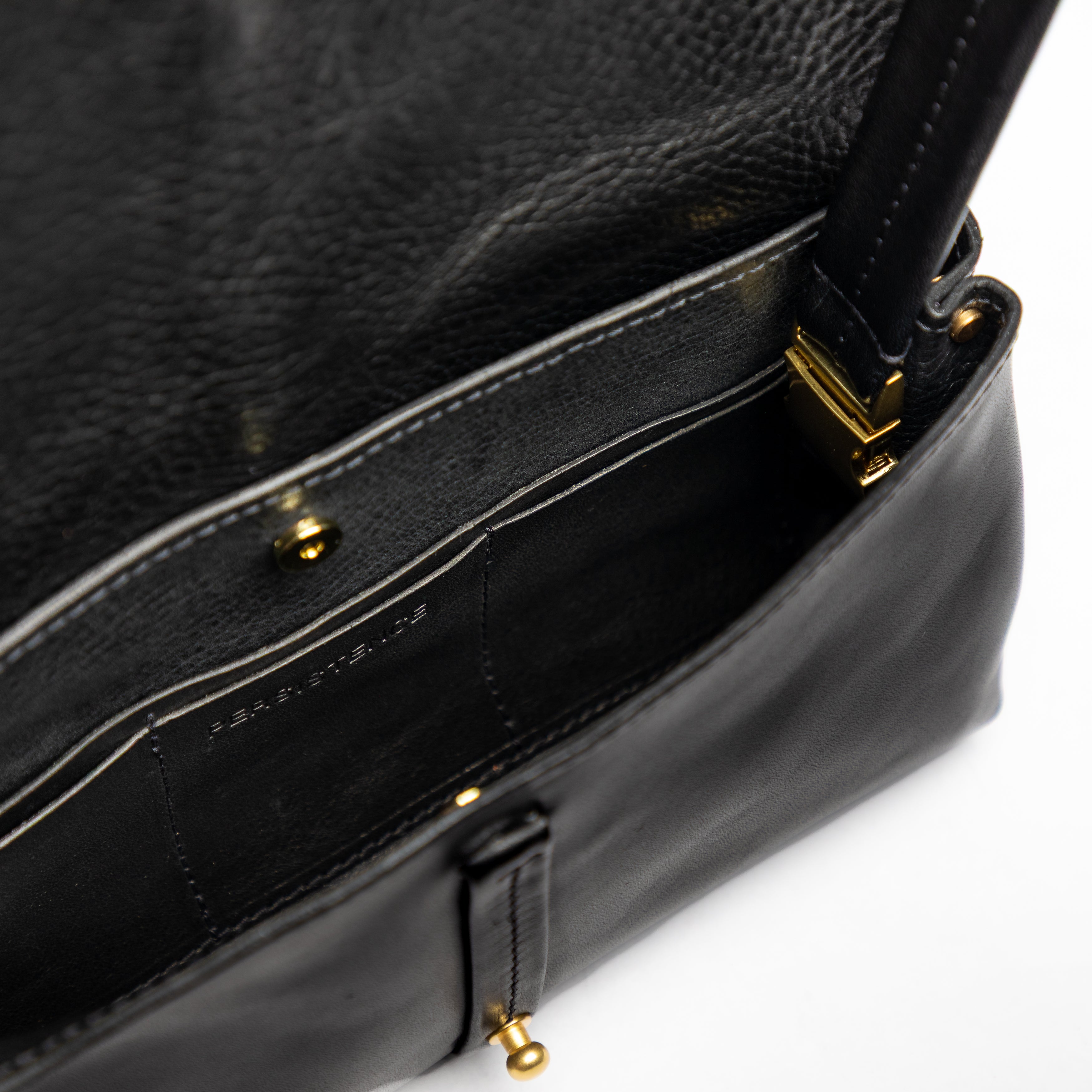 Close-up of open Festival Bag | Black showcasing its smooth full-grain leather interior and refined gold-tone hardware detail
