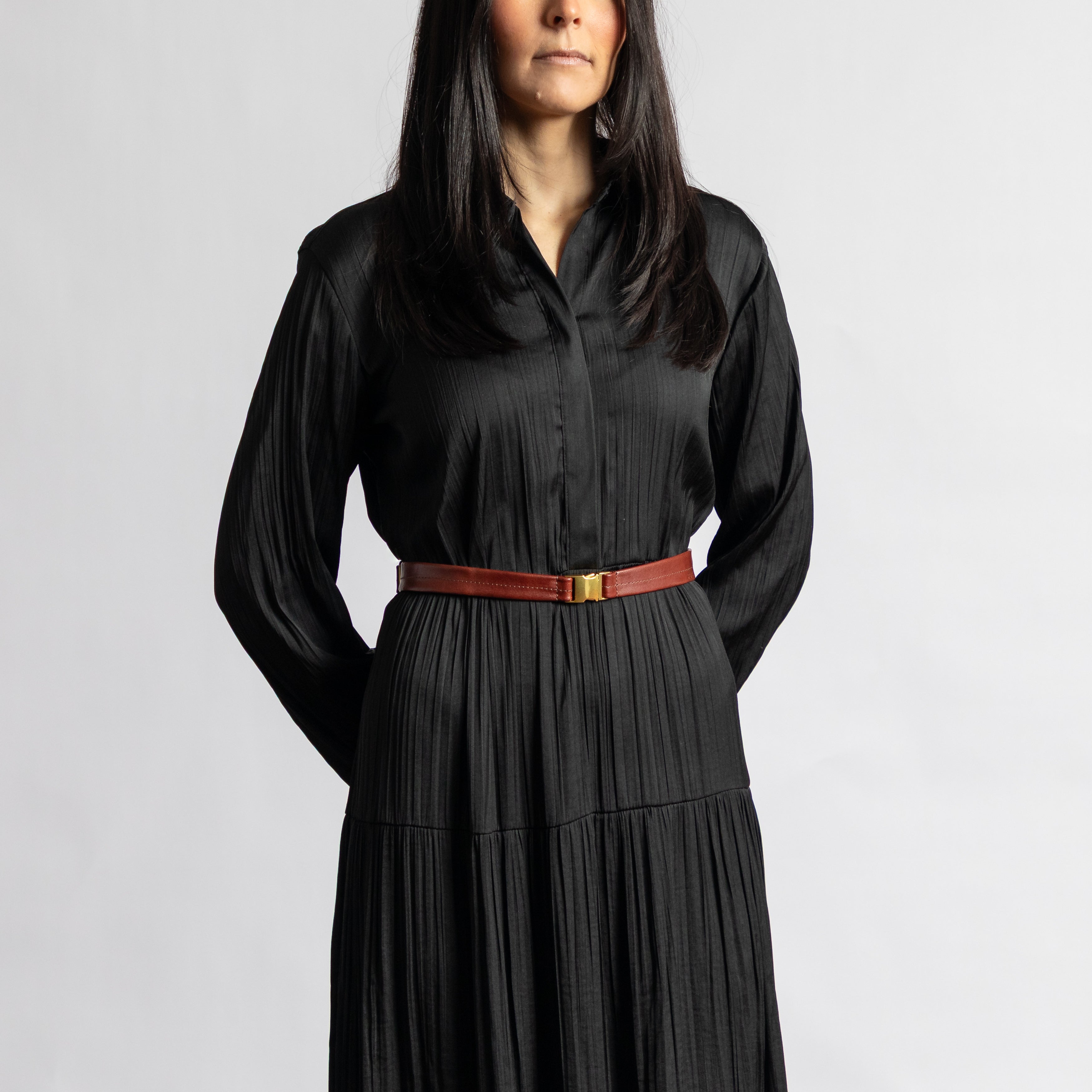 Woman wearing a luxury smooth full-grain leather Festival Bag | Sangria styled as a belt bag with gold-tone hardware clasp